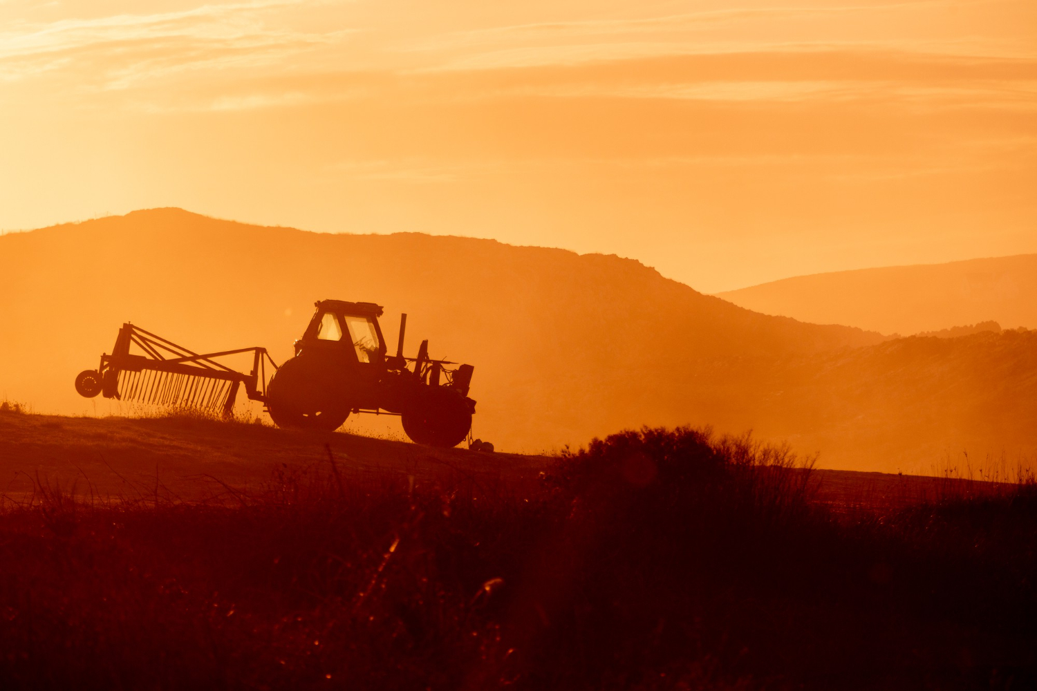 tractor-farm-field-sunset-backlight-warm-tones